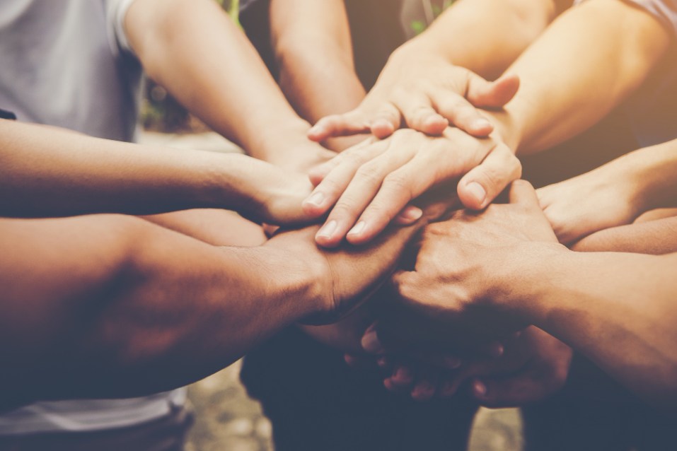 trabajo-en-equipo-colaboración-manos-unidas