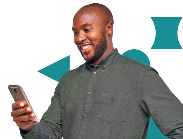 Kenyan man smiling while looking down at his phone after Tala's advanced AI credit engine has approved his loan request